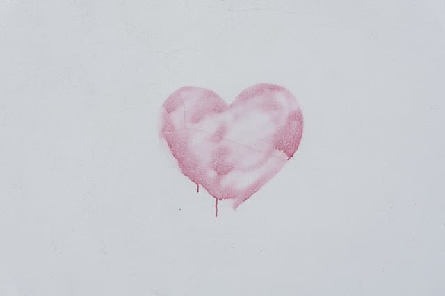 Pink heart painted on a white wall
